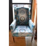 An Edwardian wing back armchair