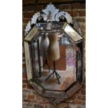An ornate etched Venetian style wall mirror