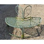 A semi-circular green painted metal garden half tree bench