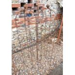 A trio of weathered steel ball head garden obelisks, 115 cm x 30 cm