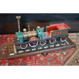 A painted metal model of an early steam engine