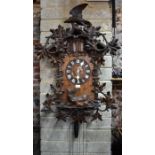 A large late 19th century Black Forest musical cuckoo wall clock