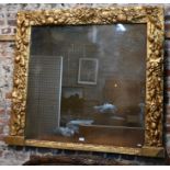 A 18th century bacchanalian style giltwood and gesso frame