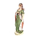 A Royal Dux figure of a young lady dressed in Empire style