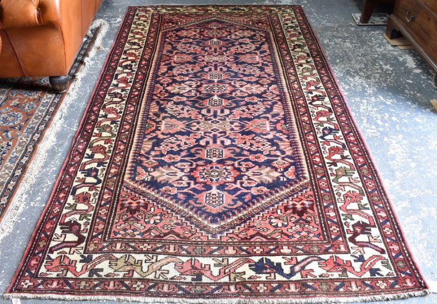 A Malayer carpet, the stylised floral design on dark blue ground