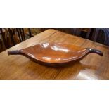 A large carved and polished wood fruit bowl of organic form