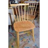 A trio of Danish design mid century elm and beech spindle back dining chairs