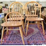 A set of four Ercol Windsor elm and beech spindle back dining chairs
