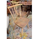 A set of four Ercol mid-century Windsor elm and beech spindle back dining chairs