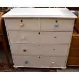 An antique cream painted chest of two short over three long drawers
