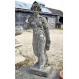 A large reconstituted weathered stone garden figure of a classical maiden