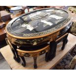 An Oriental black lacquered and gilded glass top coffee table