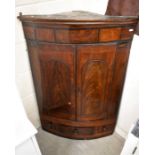 A 19th century mahogany hanging corner cupboard