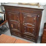 An 18th and 19th century panelled oak cupboard