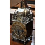 A reproduction brass lantern clock