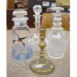 Three glass decanters/carafes and brass candlestick