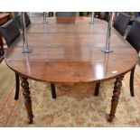 A 19th century fruitwood extending dining table