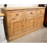 An antique pine dresser base with three drawers