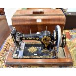 An antique Jones sewing machine with rosewood centre