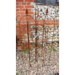 Four weathered steel arrowhead obelisks