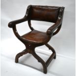 An antique X-framed leather chair