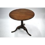 A George III mahogany circular tilt top tripod table