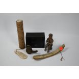 A collection of Indonesian artefacts including bamboo and rib-bone batak calendars