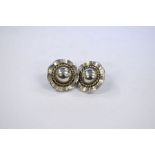 A pair of contemporary circular stylised flower style earrings