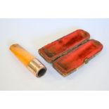 An amber and 9ct gold cheroot holder in fitted case