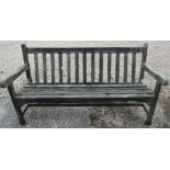 A weathered Geebro brand teak garden bench