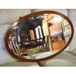 An Edwardian bevelled oval mirror