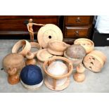 A box of various wooden hat forms