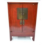 An antique Chinese red lacquer Chinese cabinet