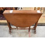 A stained yew wood drop leaf dining table