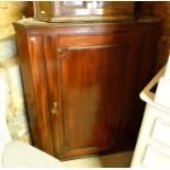 A 19th century mahogany hanging corner cupboard