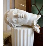 A cream-painted classical pillar with bust of Aphrodite