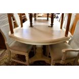 An off-white continental style extending dining table and chairs