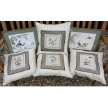 A set of four cream silk slub cushions