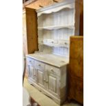 A pine dresser wtih white distress painted finish
