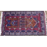 A Persian Bokhara rug and two Baluch prayer rugs
