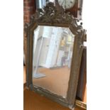 An antique French giltwood and composite framed mirror