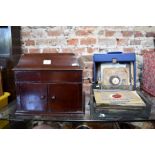 A vintage oak cased HMV wind-up gramophone and 78's