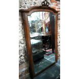 A vintage French oak framed arched top mirror