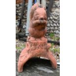 A cast terracotta squirrel ridge tile