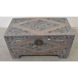 A profusely carved Chinese limed hardwood blanket chest