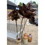 Four various decorative weathered metal flowers on poles (4)