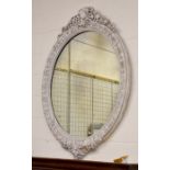 A large antique oval wall mirror