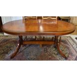 A Regency style yew veneered extending dining table and chairs