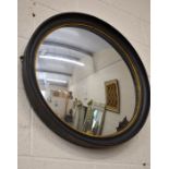 Regency style convex mirror in ebonised frame with gilt markings