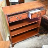 A reproduction open bookcase with two short frieze drawers